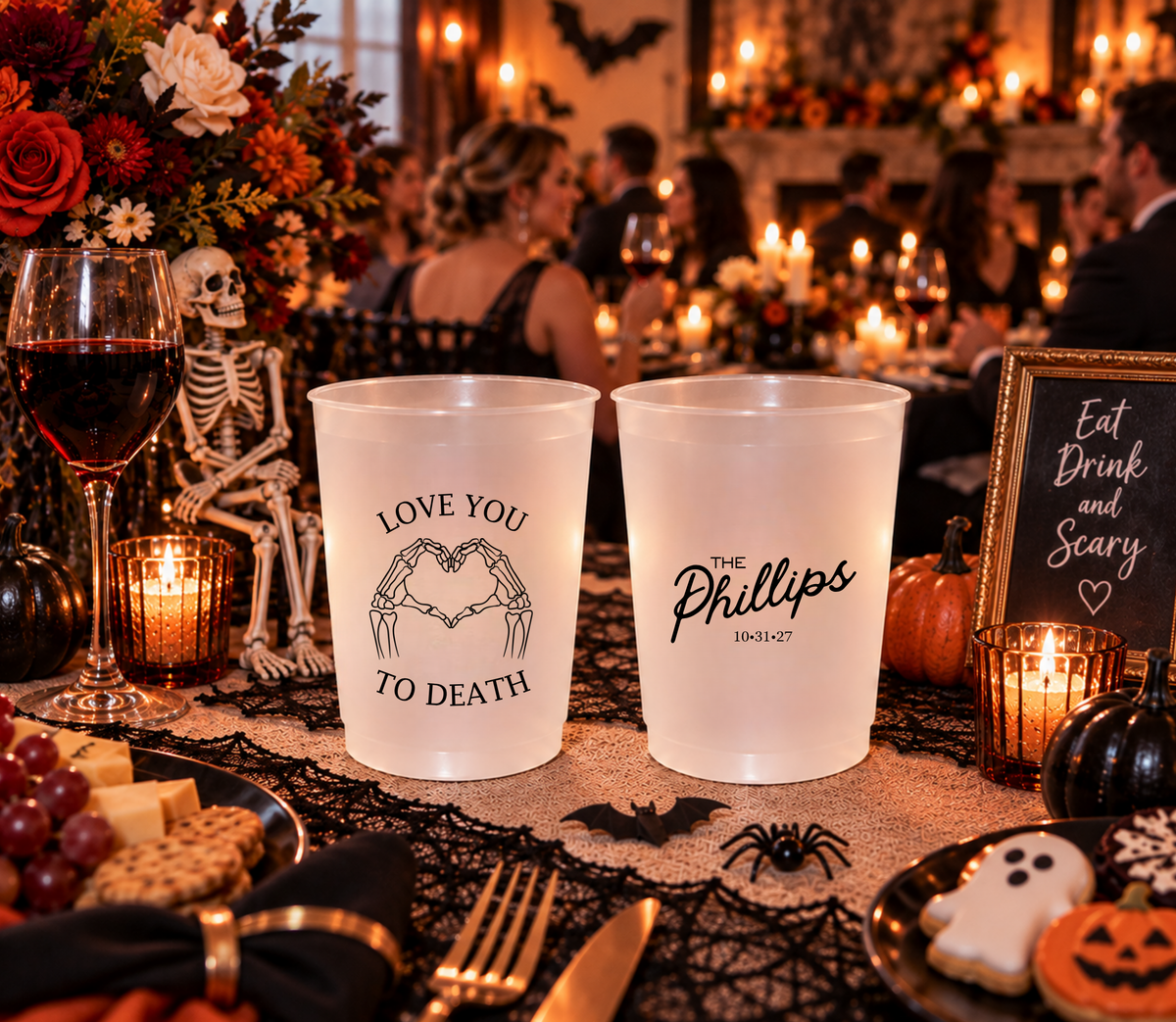 Black and frosted Love You to Death wedding cups featuring romantic heart-shaped skeleton hand artwork.