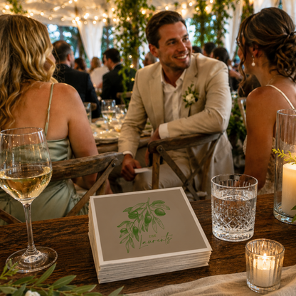 
Taupe personalized olive wedding cocktail napkins featuring an elegant olive branch illustration, custom family surname Laurents, and wedding date.