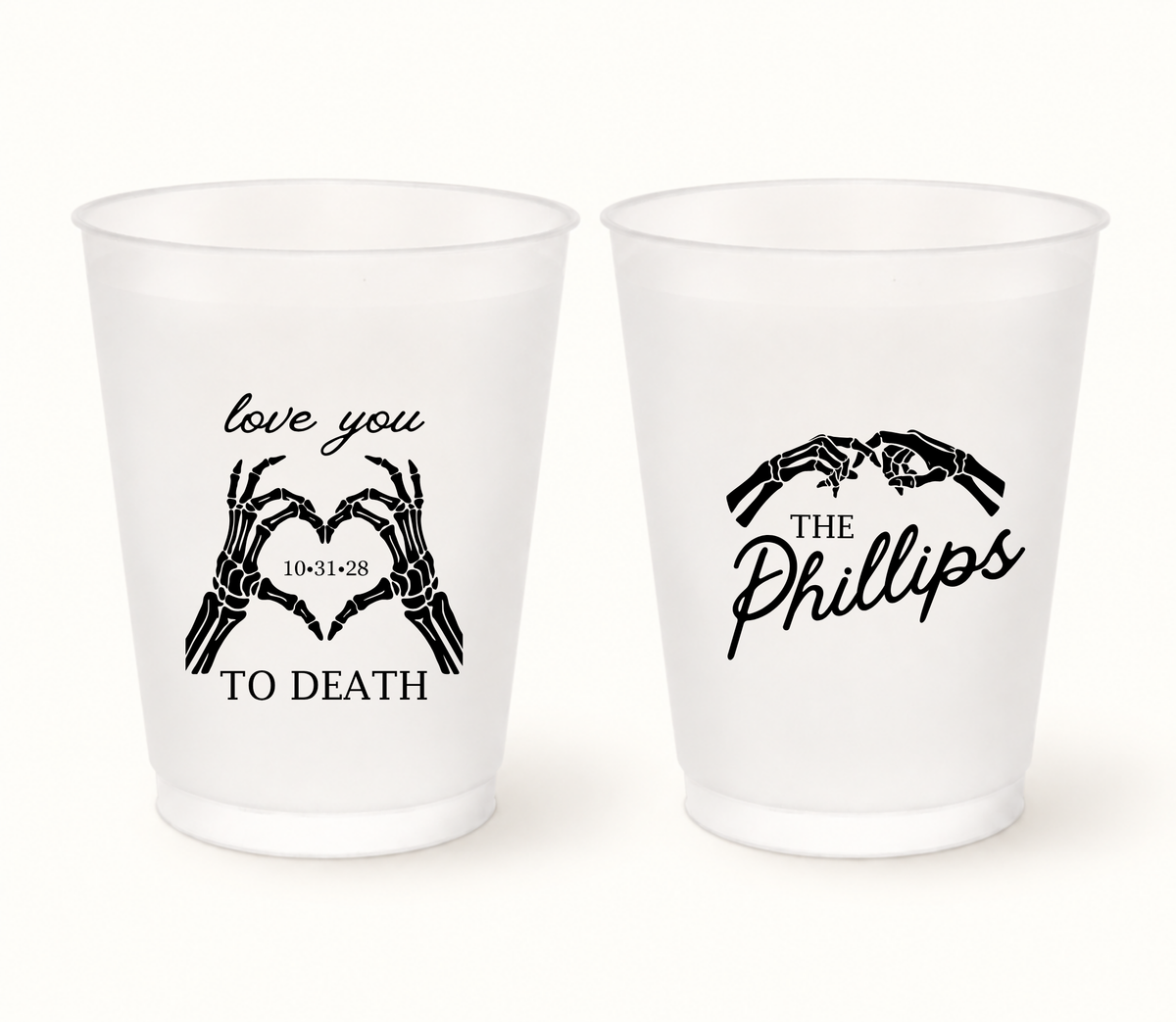 Personalized Love You to Death frosted Halloween wedding cups featuring black skeleton hands forming hearts, The Phillips last name, and wedding date 10.31.28.