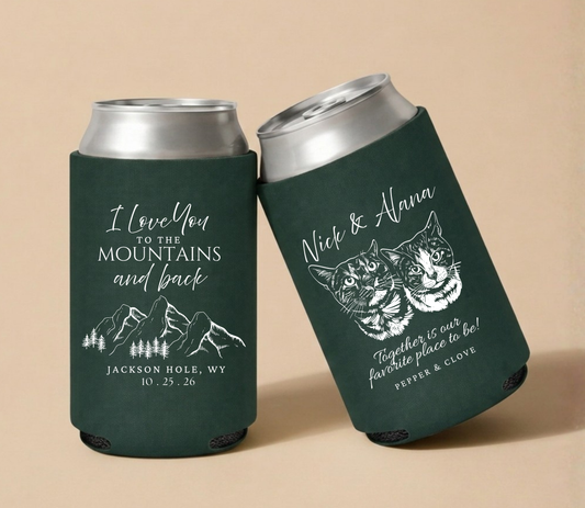 Dark green personalized wedding can coolers featuring custom cat portraits, mountain artwork, couple names, wedding location, and wedding date.

