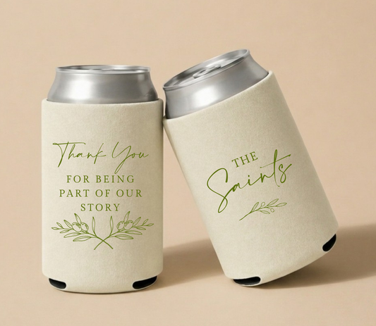 Cream personalized wedding can coolers featuring botanical olive branch artwork, heartfelt thank you message, custom family name The Saints, and wedding date.
