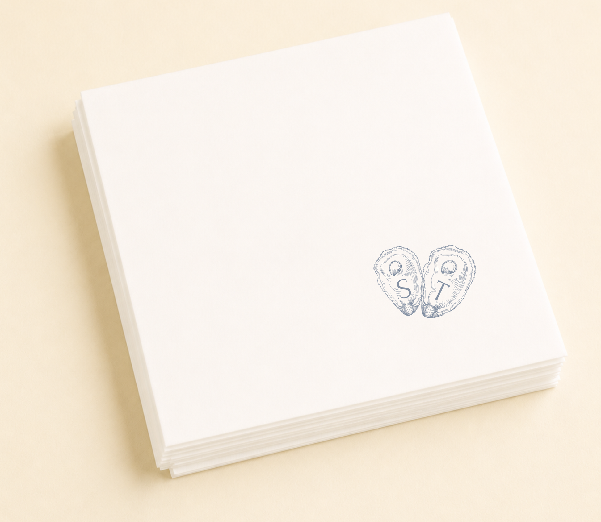 Personalized oyster wedding napkins with blue shell initials on white paper napkins for coastal wedding favors and table decor
