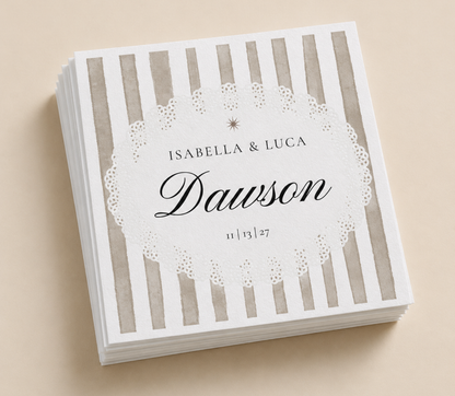 Personalized striped wedding napkins with custom names, wedding date, and black script design on gray and white paper napkins