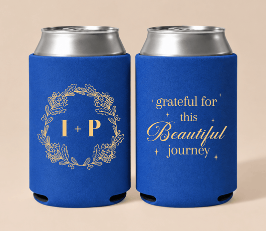 Personalized royal blue wedding can coolers featuring gold floral wreath initials and a grateful journey message for a Thanksgiving wedding.