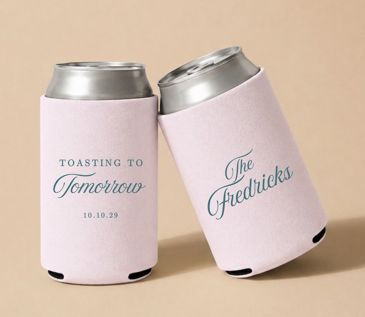 Blush pink personalized foam wedding can coolers featuring "Toasting to Tomorrow" design, custom Fredericks family name, and wedding date October 10, 2029.
