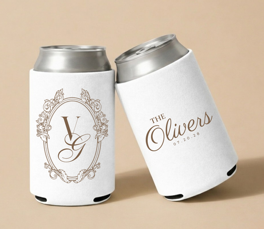 White personalized foam wedding can coolers featuring an ornate vintage monogram with initials VG, family name The Olivers, and wedding date July 20, 2028.  