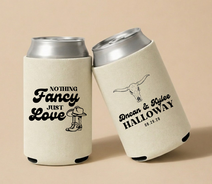 Personalized western wedding can coolers with black longhorn skull artwork, cowboy boot design, custom names, and wedding date on cream drink sleeves

