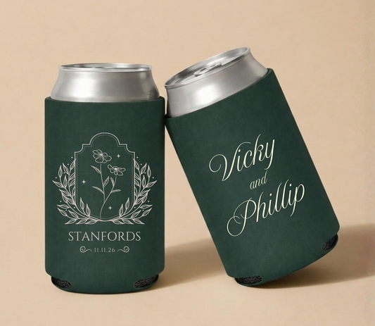 Dark green personalized wedding can coolers featuring elegant wildflower botanical artwork, custom couple names Vicky and Phillip, the family name Stanfords, and wedding date.
