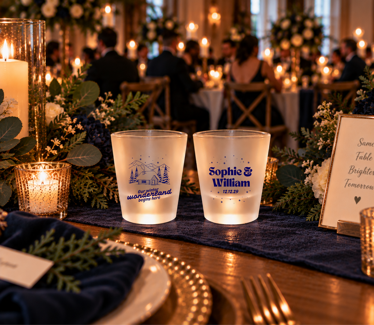 Christmas wedding shot glasses with mountain cabin, pine trees, snow, custom names, and wedding date.