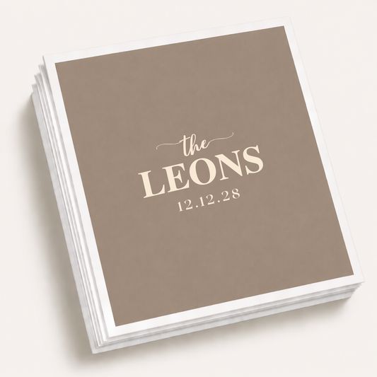Taupe personalized minimalist wedding cocktail napkins featuring custom family surname Leons and wedding date in elegant typography.
