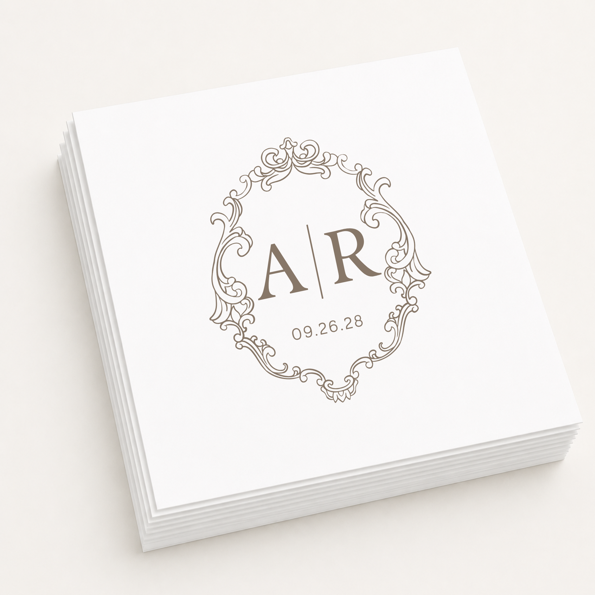 White personalized wedding cocktail napkins featuring an elegant vintage monogram frame, custom initials A and R, and wedding date 09.26.28.