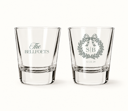 Personalized wedding shot glasses featuring a delicate bow and botanical wreath, custom monogram, family name, and wedding date.
