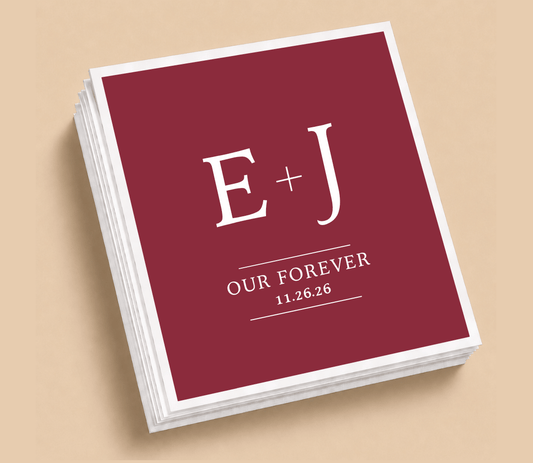 Personalized Our Forever wedding table napkins featuring custom initials, wedding date, white typography, and a burgundy background.