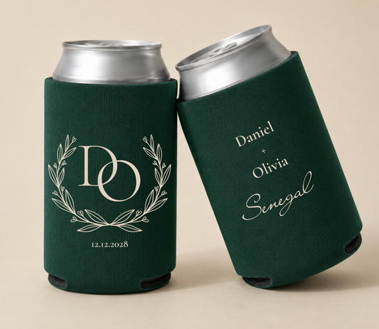 Dark green personalized wedding can coolers featuring a custom laurel monogram, couple initials D and O, wedding date, and personalized names Daniel and Olivia.

