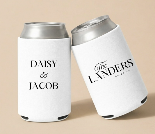 Personalized white wedding can coolers featuring custom couple names, family name, and wedding date in elegant black typography for modern wedding celebrations.