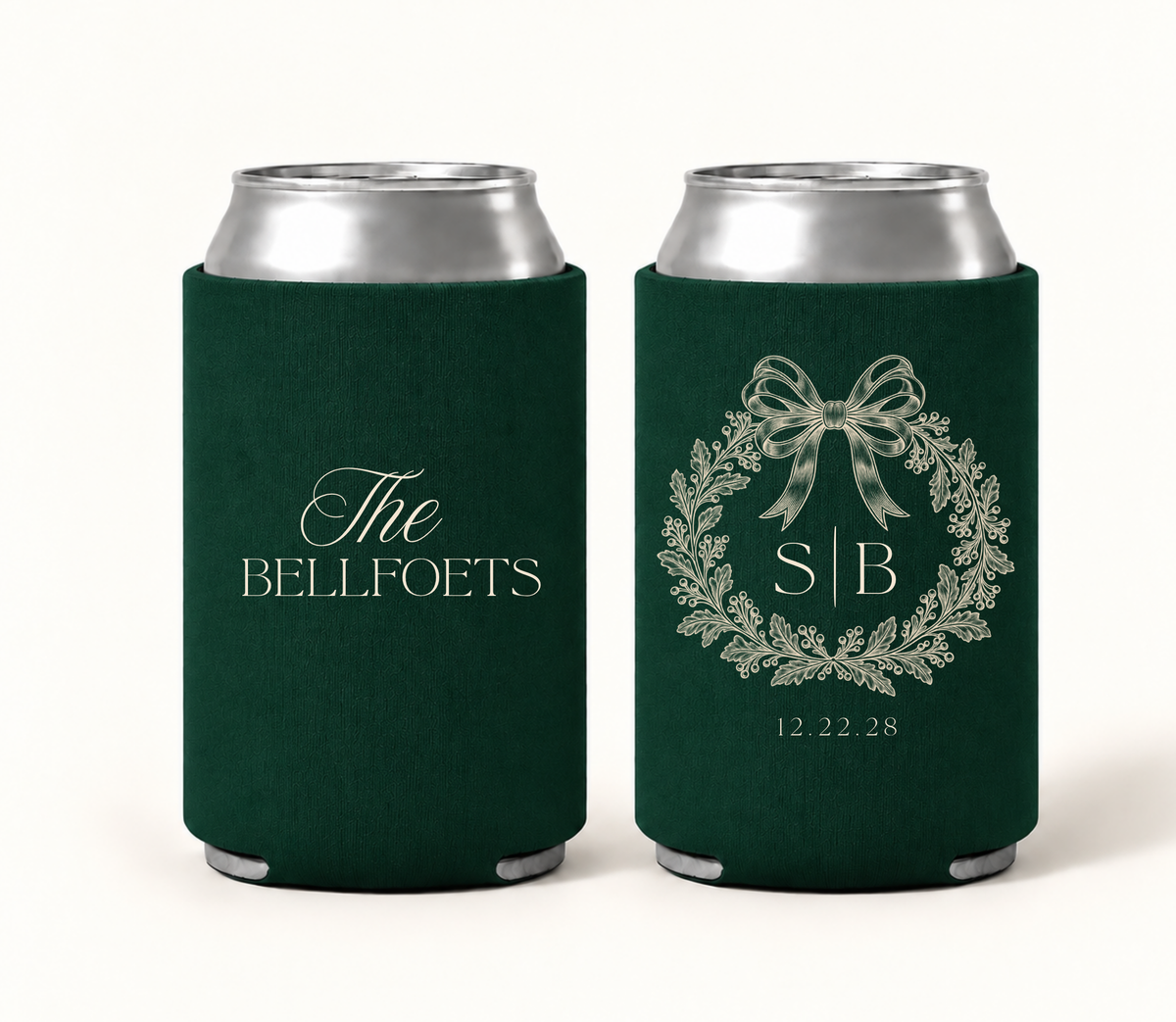 Personalized emerald green bow wedding can coolers featuring ivory botanical wreath artwork, decorative bow, custom couple initials, family name, and wedding date.