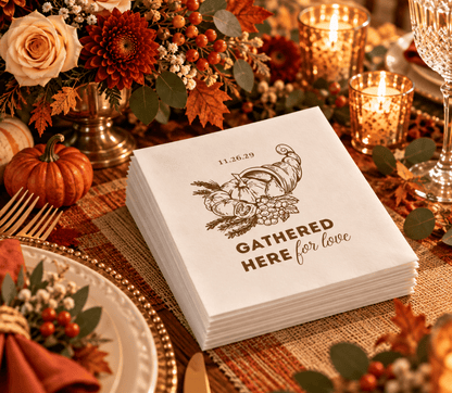 White Thanksgiving wedding table napkin featuring a detailed autumn harvest cornucopia and brown lettering.