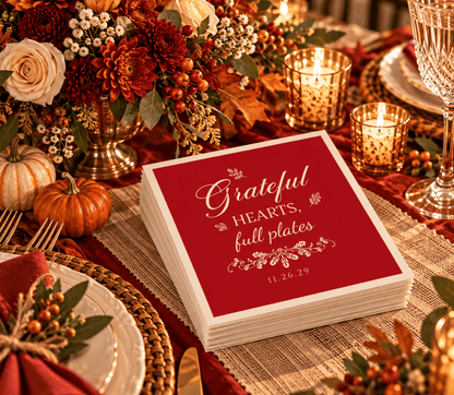 Red Thanksgiving wedding table napkins featuring elegant cream typography and decorative botanical accents.