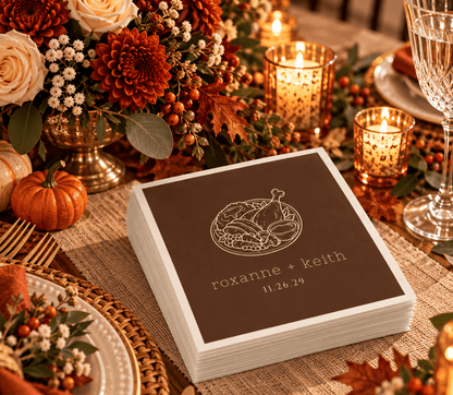 Brown Thanksgiving wedding table napkins featuring a detailed turkey dinner illustration and cream personalized lettering.