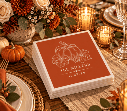 Terracotta Thanksgiving wedding napkins featuring a detailed pumpkin and autumn leaves with custom family name.