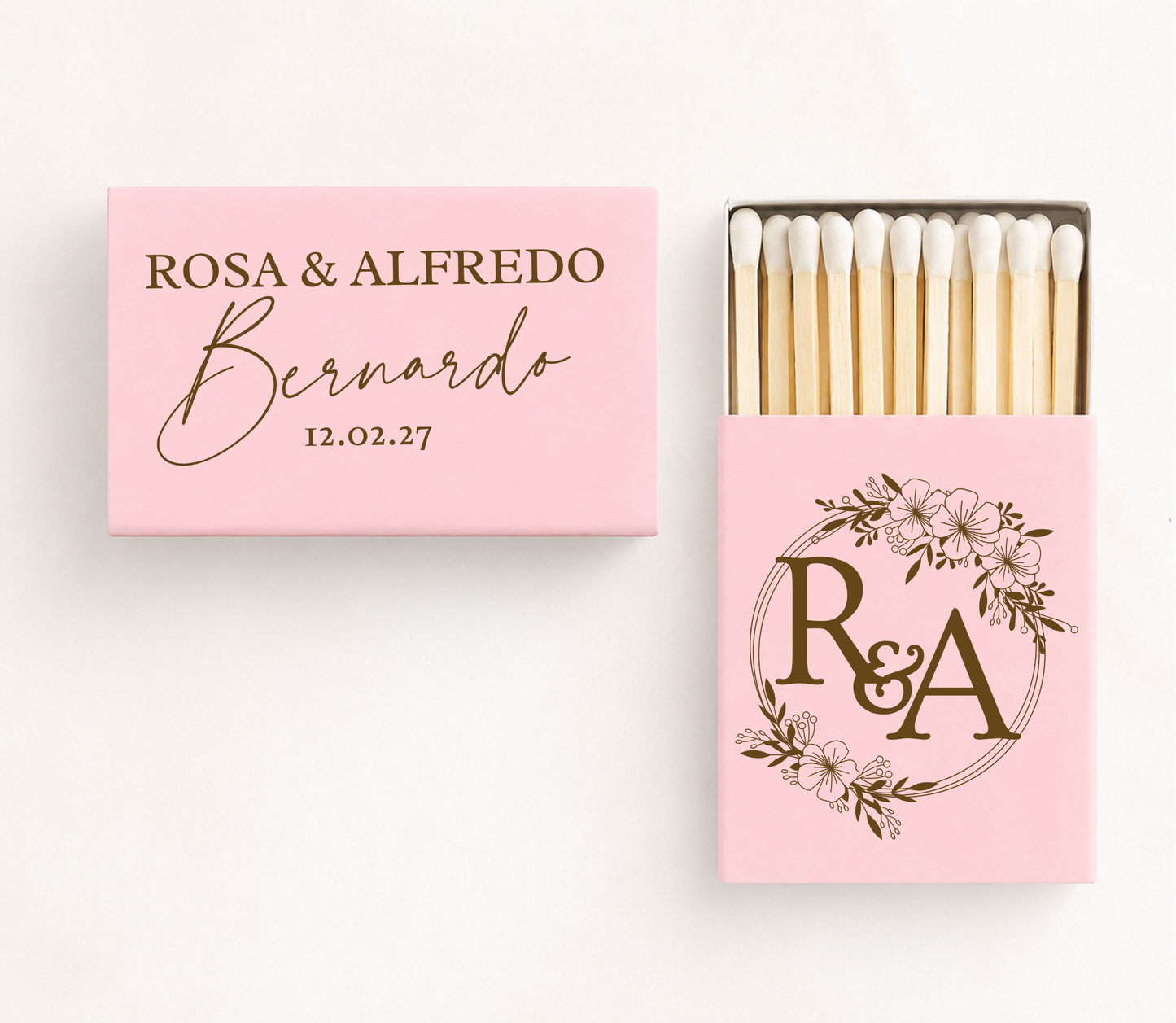 Personalized floral monogram wedding matchboxes featuring custom couple names, family name, wedding date, and floral wreath initials.