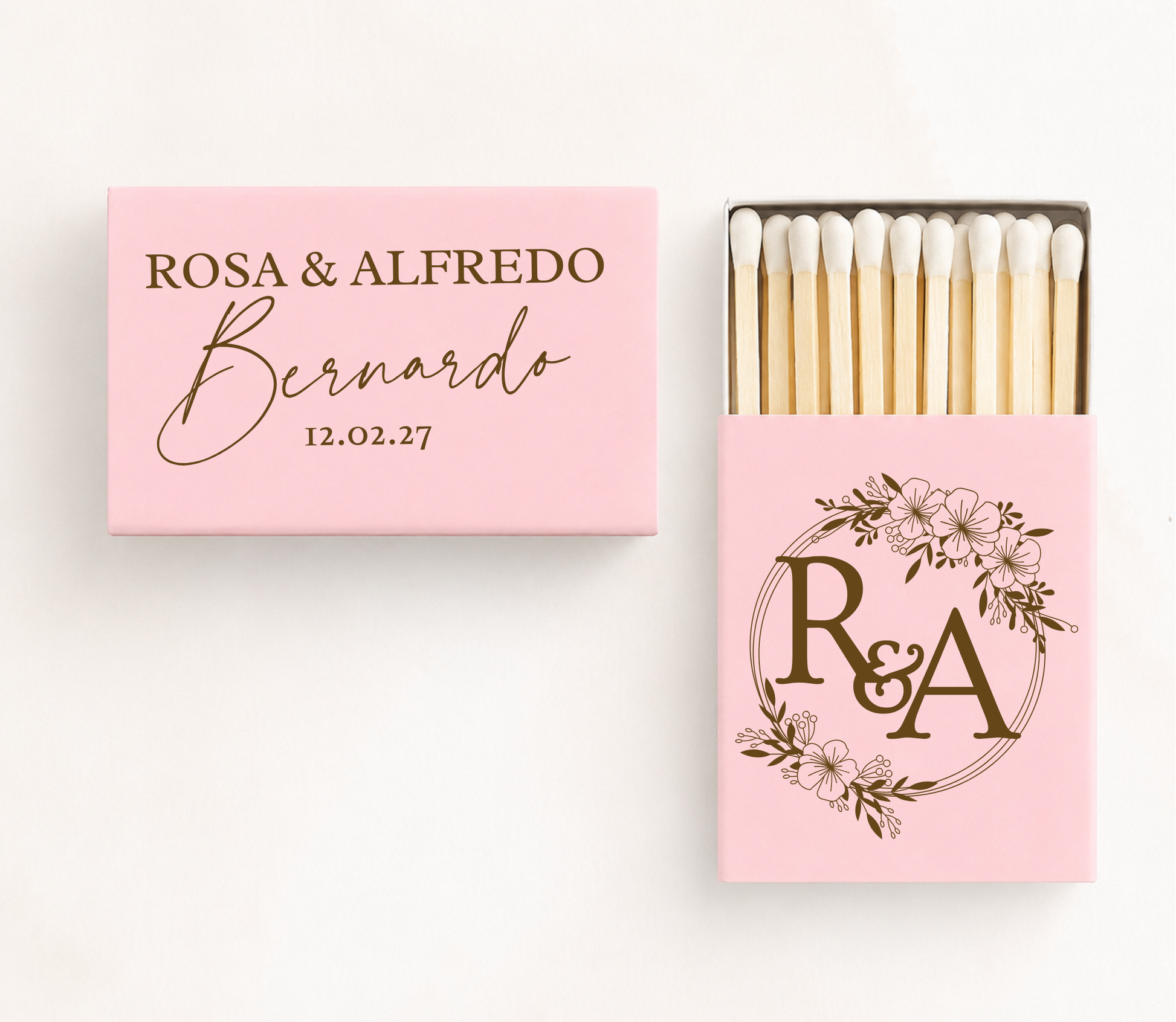 Personalized floral monogram wedding matchboxes featuring custom couple names, family name, wedding date, and floral wreath initials.