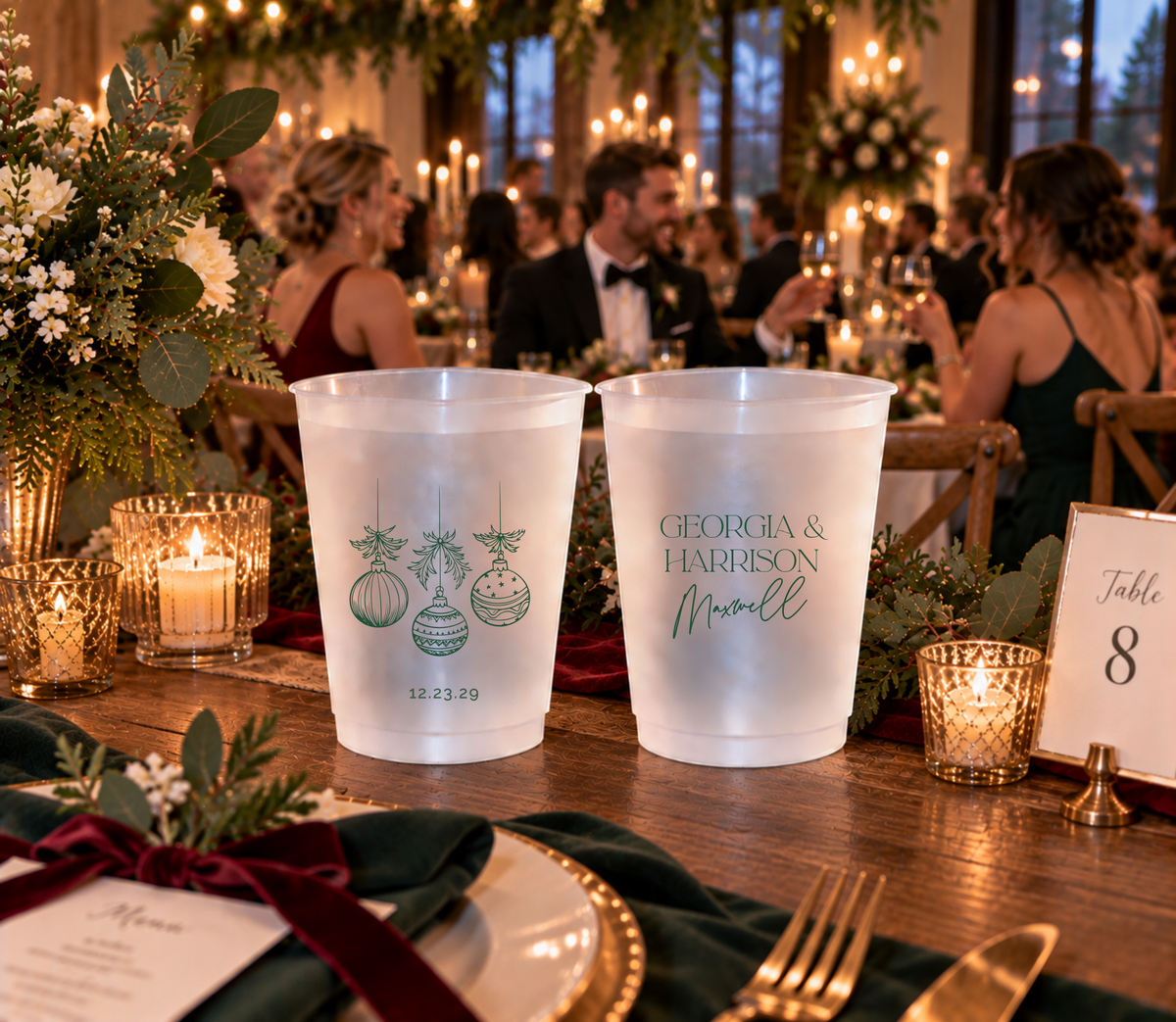 Holiday wedding drink cups featuring elegant Christmas ornament artwork and custom names.