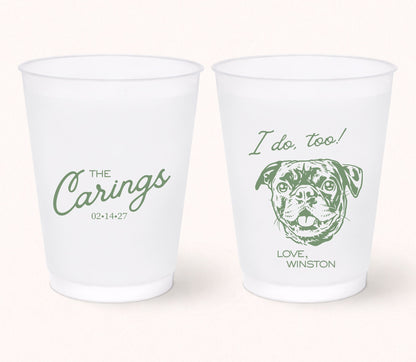 Two personalized frosted wedding cups featuring the family name The Carings, a custom pug portrait with the phrase "I Do, Too!", pet name Winston, and wedding date 02.14.27 printed in sage green.
Personalized frosted wedding cup featuring a custom dog portrait and the phrase "I Do, Too!"
Custom pet portrait wedding cup with family name, wedding date, and playful dog illustration.