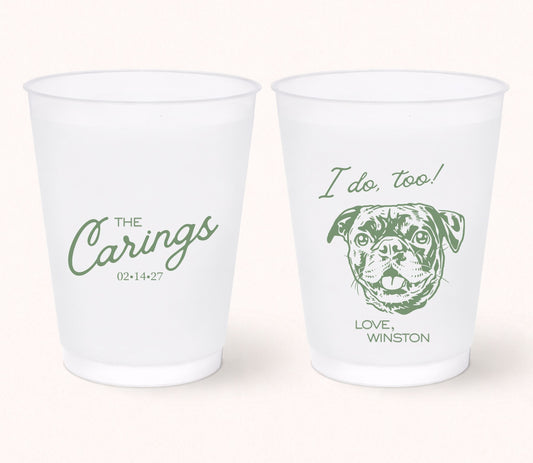 Two personalized frosted wedding cups featuring the family name The Carings, a custom pug portrait with the phrase "I Do, Too!", pet name Winston, and wedding date 02.14.27 printed in sage green.
Personalized frosted wedding cup featuring a custom dog portrait and the phrase "I Do, Too!"
Custom pet portrait wedding cup with family name, wedding date, and playful dog illustration.