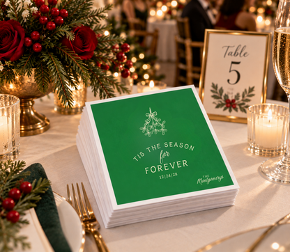 Romantic winter wedding napkins with Tis The Season For Forever wording, Christmas greenery illustration, and custom names.