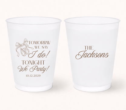 Personalized rehearsal dinner frosted cups featuring the phrase "Tomorrow We Say I Do, Tonight We Party!" with a custom family name and wedding date for wedding weekend celebrations.