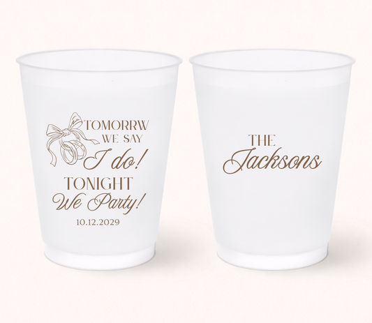 Personalized rehearsal dinner frosted cups featuring the phrase "Tomorrow We Say I Do, Tonight We Party!" with a custom family name and wedding date for wedding weekend celebrations.