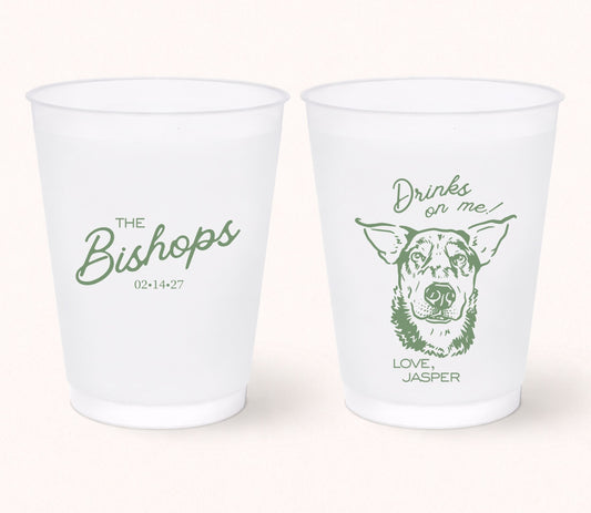 Two personalized frosted wedding cups featuring The Bishops with wedding date 02.14.27 on one side and a custom dog portrait with the phrase "Drinks On Me!" signed Love, Jasper on the reverse in sage green.
Personalized wedding frosted cup featuring a custom dog portrait with the phrase "Drinks On Me!"
Reusable frosted wedding cup with personalized family name, wedding date, and dog illustration.
