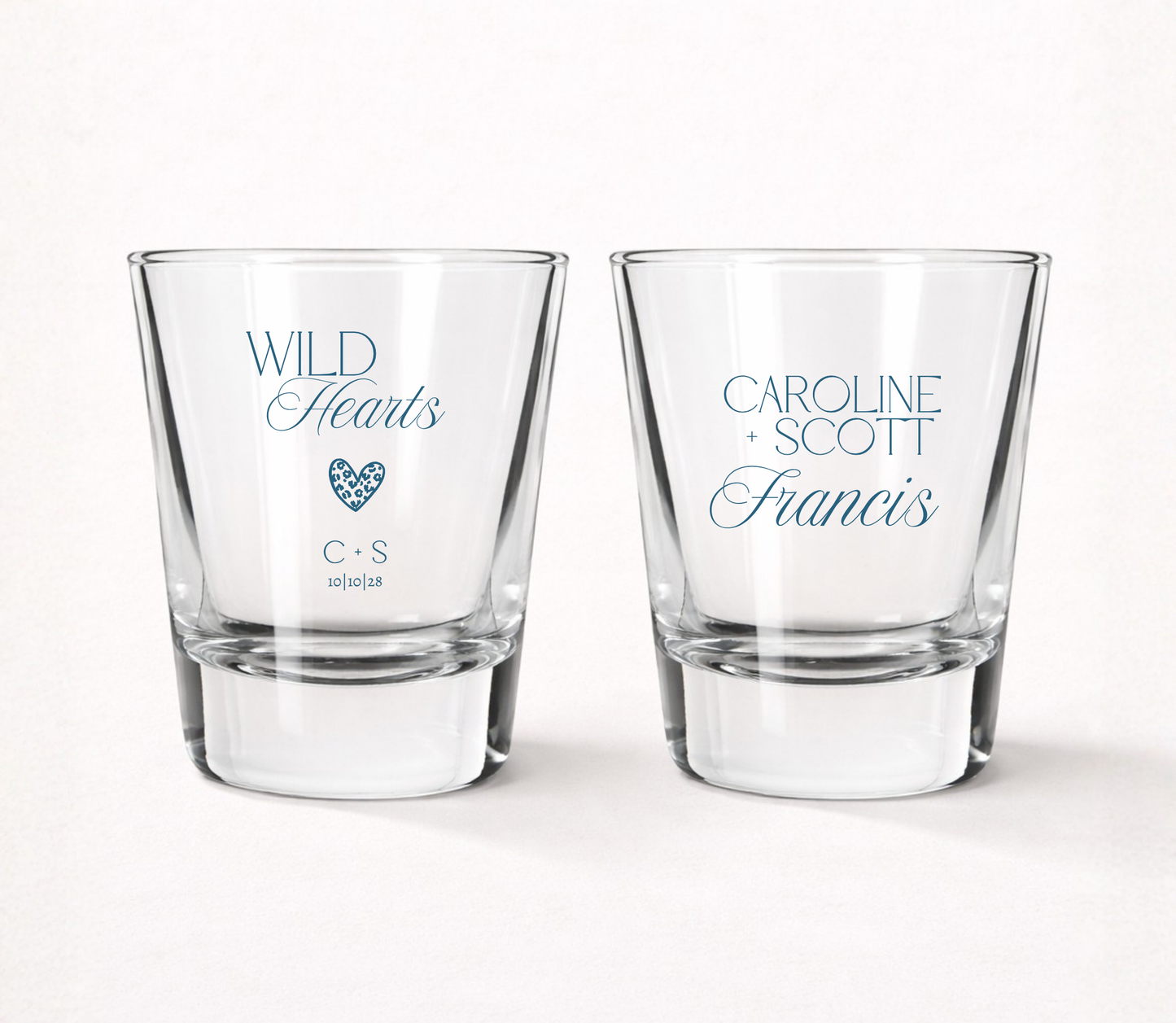 Personalized Wild Hearts wedding shot glasses featuring custom couple names, initials, wedding date, and modern heart design.