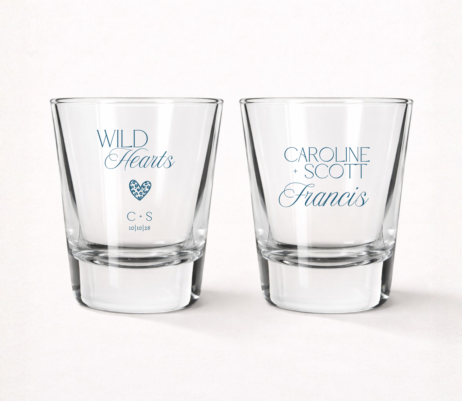 Personalized Wild Hearts wedding shot glasses featuring custom couple names, initials, wedding date, and modern heart design.
