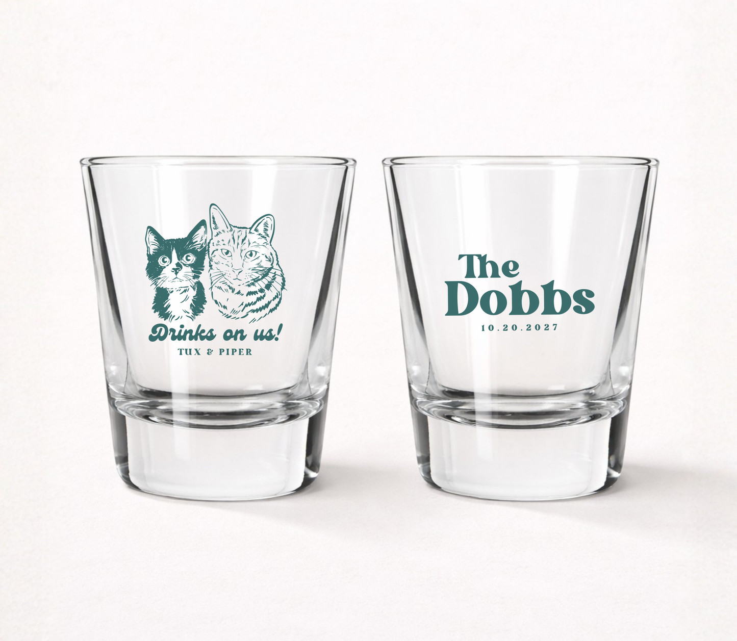 Clear personalized wedding shot glasses featuring custom dog and cat portrait illustrations, family surname, pet names, and wedding date.