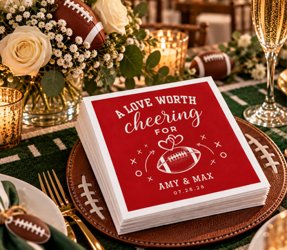 Personalized football wedding reception napkins featuring megaphone artwork, romantic hearts, bold white lettering, and custom couple names.