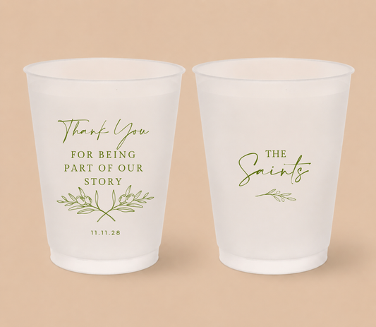 White frosted wedding cups featuring olive branch artwork, The Saints family surname, thank you message, and wedding date for a Mediterranean inspired wedding.