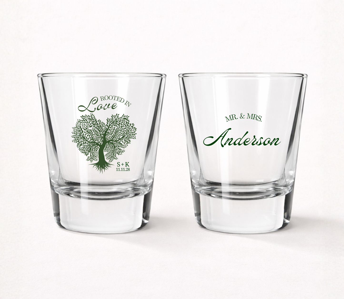 Personalized Rooted in Love wedding shot glasses featuring a custom family name, couple initials, wedding date, and elegant tree illustration.