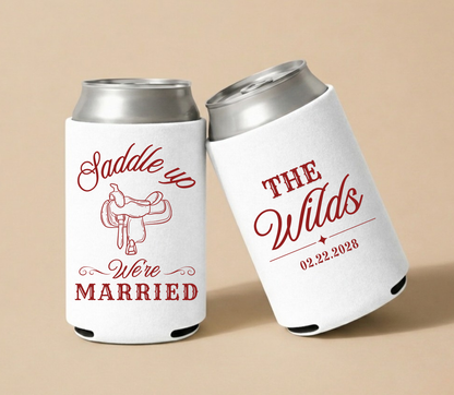 Custom Saddle Up western wedding can coolers with red saddle artwork, personalized couple name, and wedding date on white drink sleeves