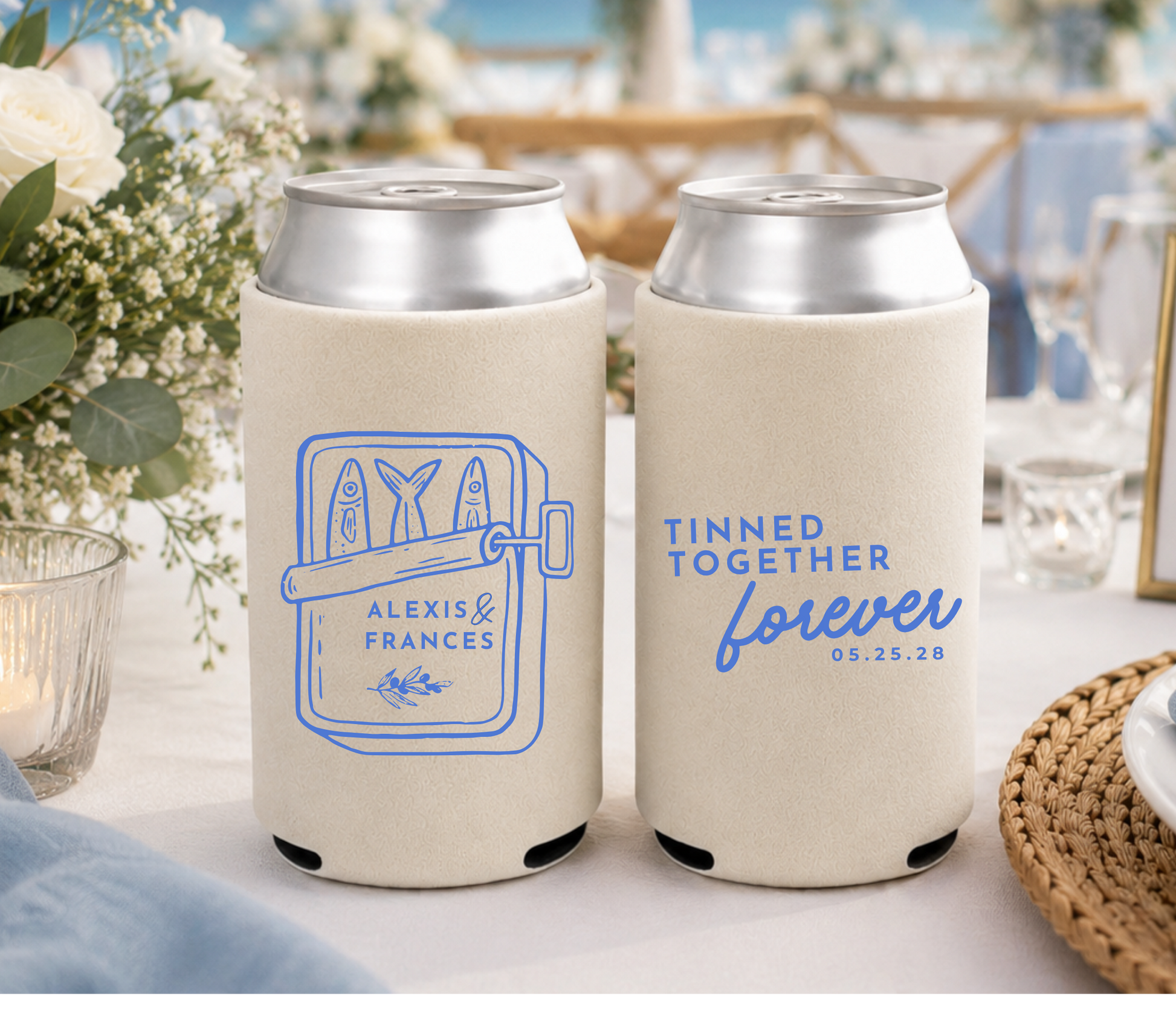 Two can coolers with personalized designs on a table with a wedding setting in the background.
