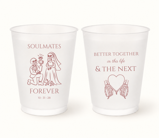 Personalized Soulmates Forever Halloween wedding frosted cups featuring dusty rose skeleton bride and groom artwork, heart-shaped skeleton hands, Better Together in This Life & The Next wording, and wedding date 10.31.28.