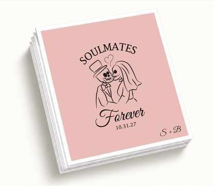 Personalized Soulmates Forever blush pink Halloween wedding cocktail napkins featuring a skeleton bride and groom, custom wedding date, and couple initials.