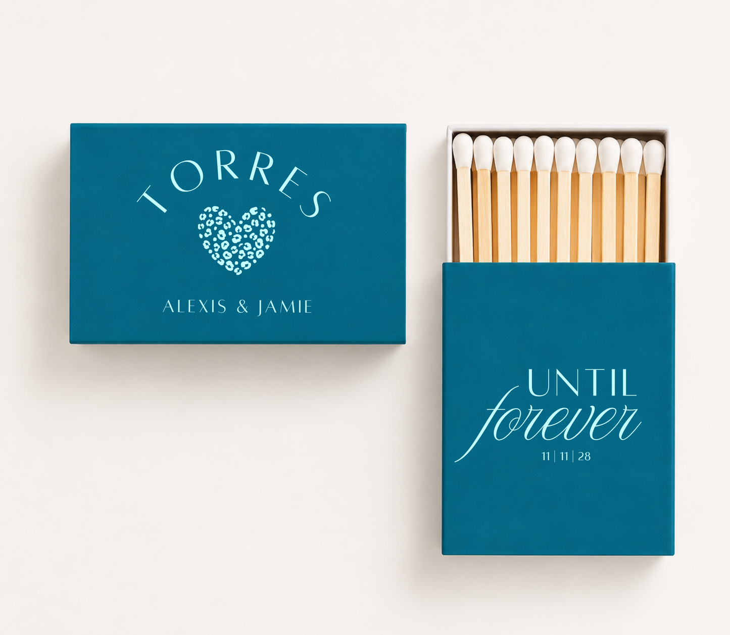 Personalized teal wedding matchboxes featuring light blue Until Forever lettering, leopard print heart, Alexis and Jamie names, and 11-11-28 wedding date.