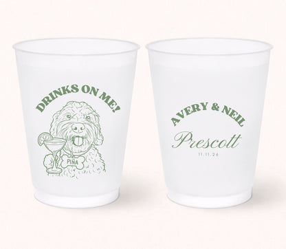 Two personalized frosted wedding cups featuring a custom dog portrait holding a cocktail with the pet name Pina on the front and Avery & Neil Prescott with the wedding date 11.11.26 on the back in sage green print.
Personalized frosted wedding cup featuring a custom dog portrait with a signature cocktail illustration.
Custom pet portrait wedding cup with dog artwork, personalized names, and wedding date.