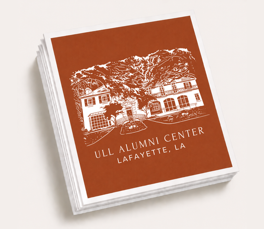 Personalized cocktail napkins featuring a custom illustration of the ULL Alumni Center in Lafayette, Louisiana.