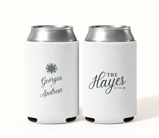 Personalized white snowflake Christmas wedding can coolers featuring evergreen green artwork, Georgia and Andrew names, The Hayes surname, and wedding date 12.14.28.
