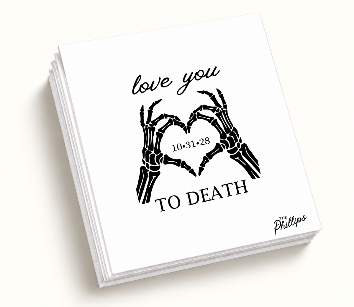 Personalized white Love You to Death wedding napkin featuring black skeleton hands forming a heart, wedding date 10.31.28, and The Phillips surname.