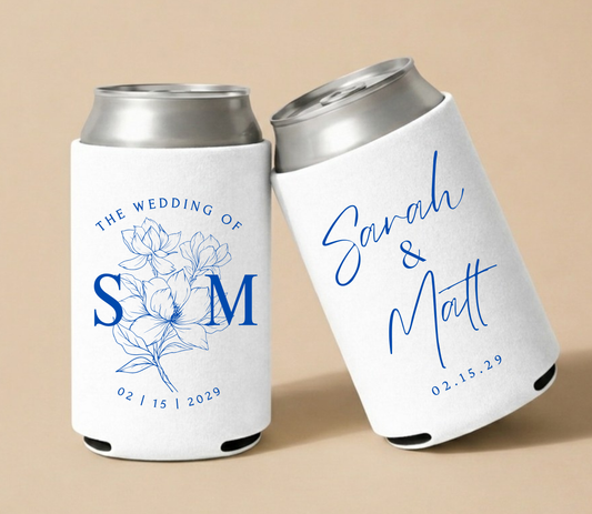 White personalized foam wedding can coolers featuring blue floral illustrations, couple names Sarah and Matt, and wedding date February 15, 2029.