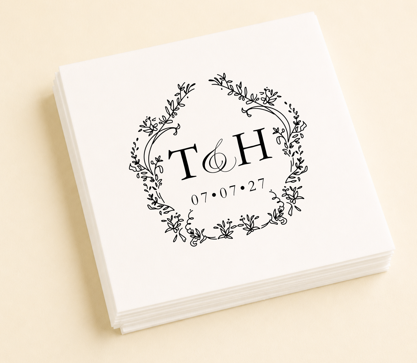 Personalized floral monogram wedding cocktail napkins featuring custom initials inside a delicate botanical wreath with wedding date.